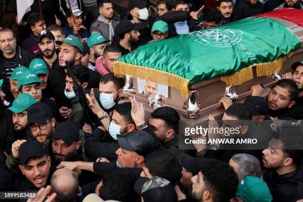 Mourners carry the coffin of Hamas' deputy leader, Saleh al-Aruri, killed on January 2, 2024 in a strike in Beirut's southern suburbs, during his...