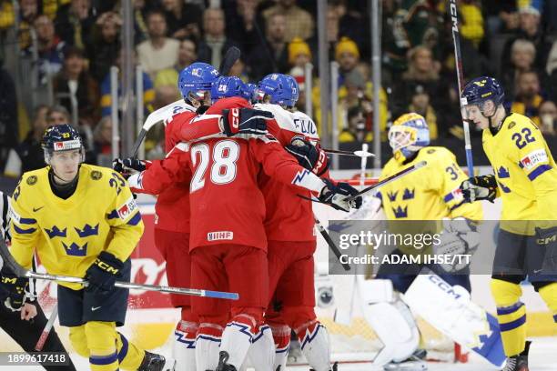 Czech players celebrate scoring the 0-1 opening goal during the IIHF World Junior Championship ice hockey semi-final match between Sweden and the...