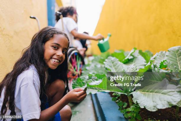 portrait of a girl student gardening at school - south american people stock pictures, royalty-free photos & images