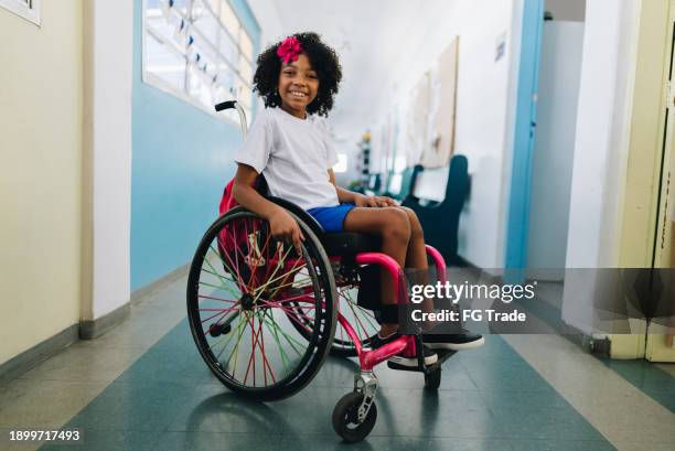 portrait of a wheelchair girl student at school - rolstoel stockfoto's en -beelden