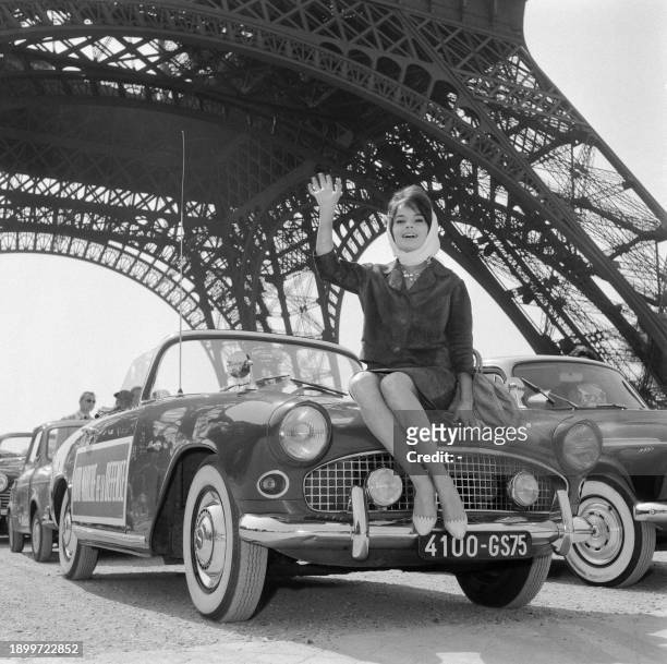 French actress Pascale Petit poses at the foot of the Eiffel Tower during the auction of her car whose profits will go to "Road Rescue" in Paris on...