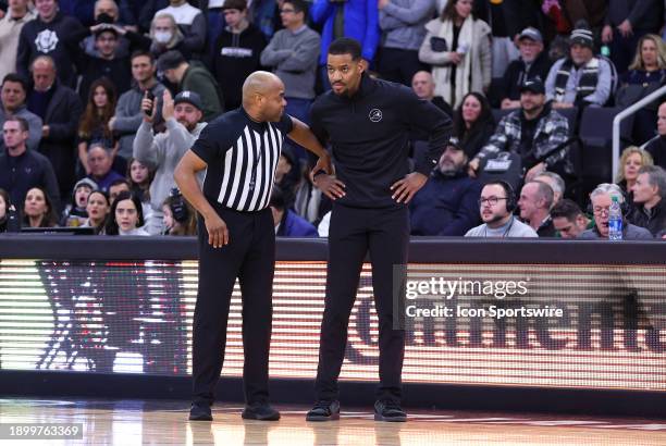 Referee Jeff Anderson speaks with Providence Friars head coach Kim English during the college basketball game between Seton Hall Pirates and...