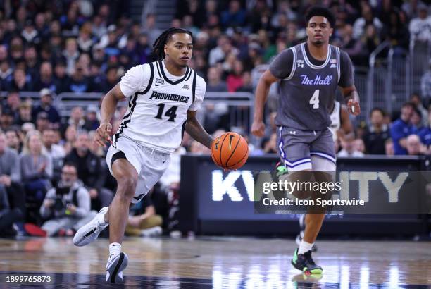 Providence Friars guard Corey Floyd Jr. Fast breaks pursued by Seton Hall Pirates center Elijah Hutchins-Everett during the college basketball game...