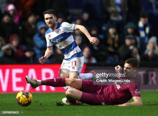 Paul Smyth of Queens Park Rangers is tackled by Mark McGuinness of Cardiff City during the Sky Bet Championship match between Queens Park Rangers and...