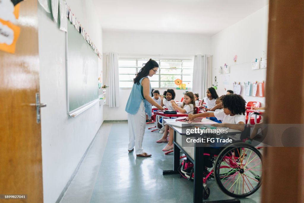 Teacher teaching on classroom at school