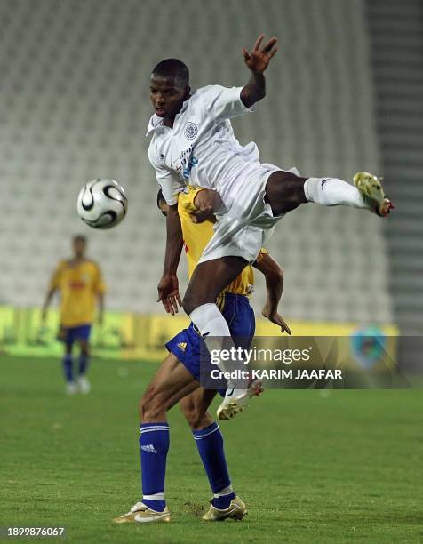 Al-Sadd's Mohammed Rabih of Oman fights for the ball with Al-Gharafa's Iraqi player Yunes Mahmud during the semi- final match of the Emir Cup soccer...