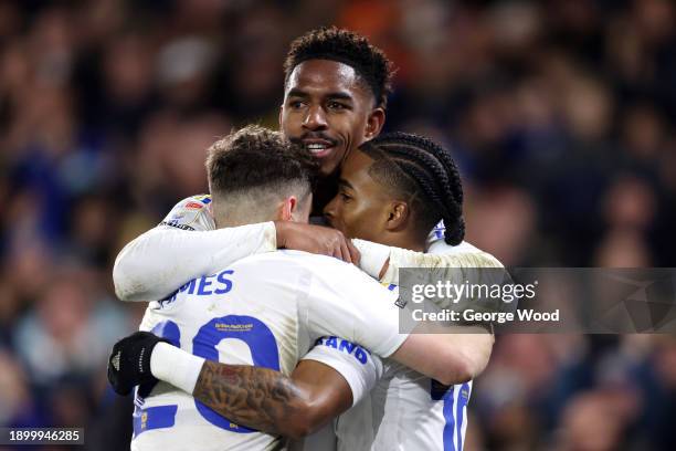 Crysencio Summerville of Leeds United celebrates with Junior Firpo and teammates after scoring their team's third goal during the Sky Bet...