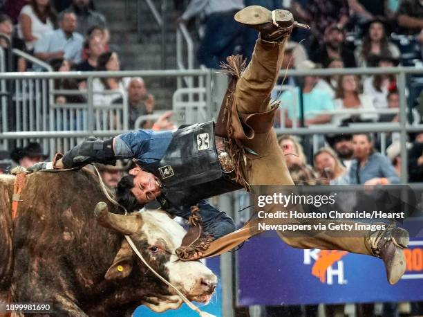 Jesse Flores is bucked off by Milburn Special during bull riding competition during the second round of Super Series I at RodeoHouston on Wednesday,...