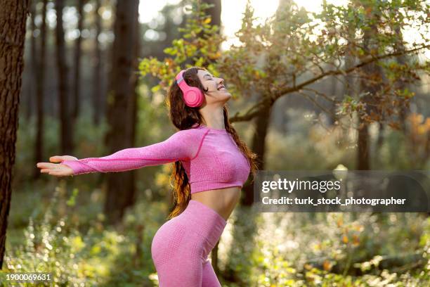 Young Athletic Woman Freely Stretching Her Arms To Nature High-Res Stock  Photo - Getty Images