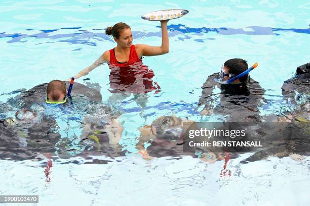 Members of The Park Club attempt to break the world record for the largest formal underwater dinner party, 22 September 2007, in London. Through out...