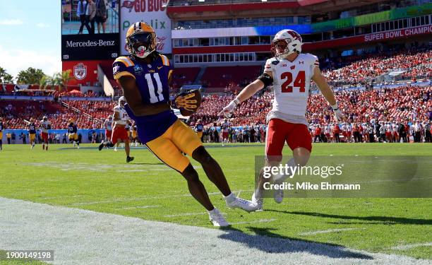 Brian Thomas Jr. #11 of the LSU Tigers makes a catch during the ReliaQuest Bowl against the Wisconsin Badgers at Raymond James Stadium on January 01,...