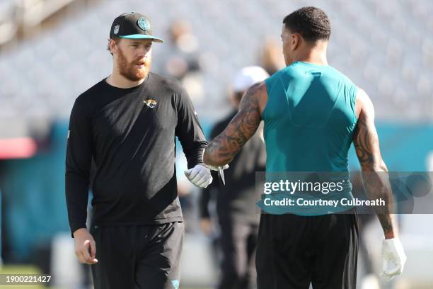 Beathard and Evan Engram of the Jacksonville Jaguars warm up before a game against the Carolina Panthers at EverBank Stadium on December 31, 2023 in...