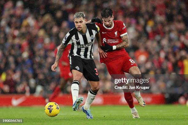 Bruno Guimaraes of Newcastle United holds off Dominik Szoboszlai of Liverpool during the Premier League match between Liverpool FC and Newcastle...