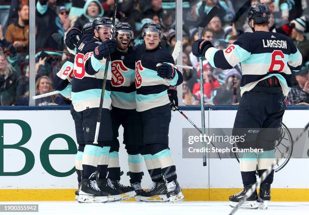 Eeli Tolvanen of the Seattle Kraken is congratulated by Vince Dunn, Yanni Gourde, Adam Larsson and Oliver Bjorkstrand after scoring a goal against...