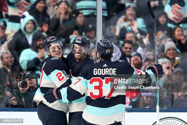 Eeli Tolvanen of the Seattle Kraken is congratulated by Yanni Gourde and Oliver Bjorkstrand after scoring a goal against the Vegas Golden Knights...