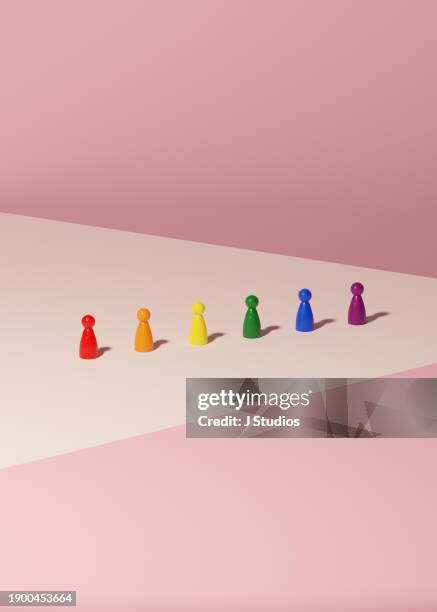 rainbow pawns in a row - transgender symbol stock pictures, royalty-free photos & images