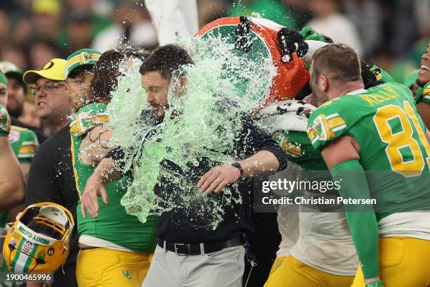 Head coach Dan Lanning of the Oregon Ducks is dunked with gatorade during the final moments of the Fiesta Bowl against the Liberty Flames at State...