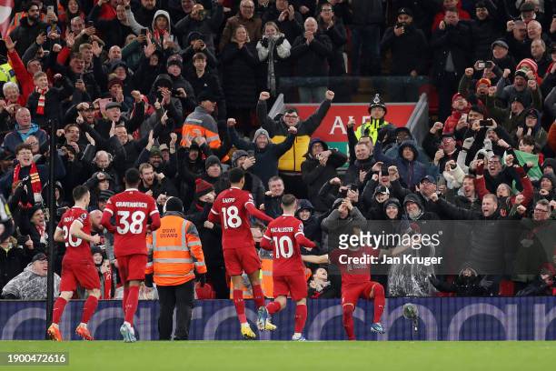 Mohamed Salah of Liverpool celebrates after scoring their sides fourth goal from the penalty spot during the Premier League match between Liverpool...