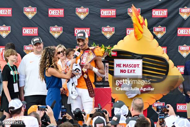 Nico Iamaleava of the Tennessee Volunteers accepts the Most Valuable Player award after defeating the Iowa Hawkeyes 35-0 to win the 2024 Cheez-It...