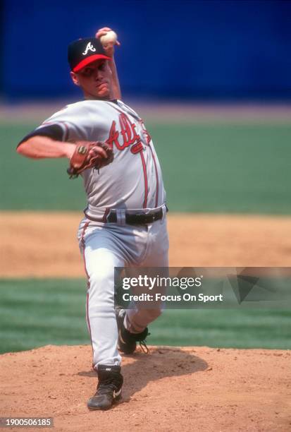 Tom Glavine of the Atlanta Braves pitches against the New York Mets during a Major League Baseball game circa 1997 at Shea Stadium in the Queens...