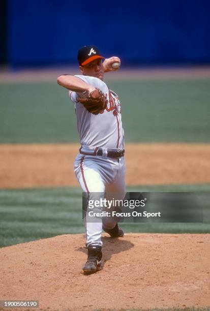 Tom Glavine of the Atlanta Braves pitches against the New York Mets during a Major League Baseball game circa 1997 at Shea Stadium in the Queens...