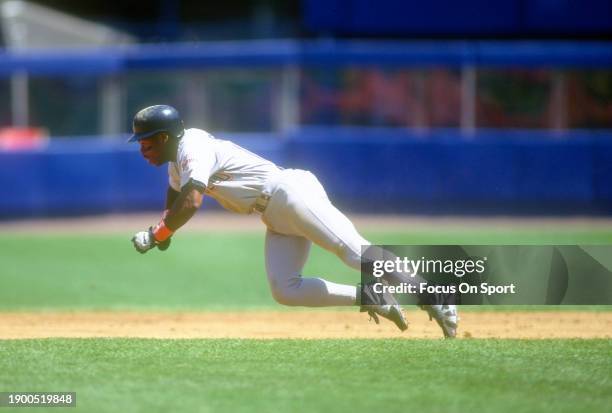 Bip Roberts of the San Diego Padres dives into third base against the New York Mets during Major League Baseball game circa 1994 at Shea Stadium in...