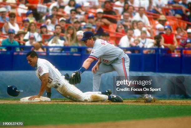 Sean Berry of the Montreal Expos at third base puts the tag on David Segui of the New York Mets during Major League Baseball game circa 1994 at Shea...