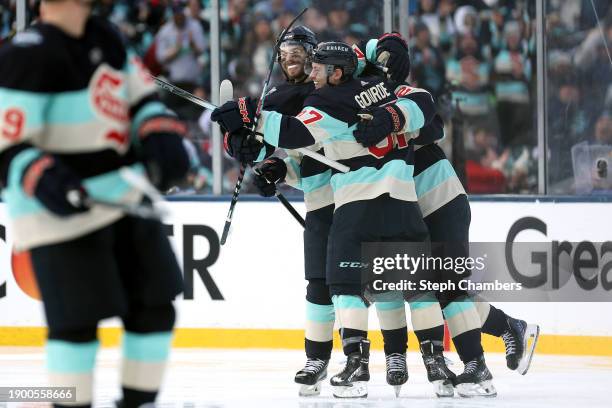 Yanni Gourde of the Seattle Kraken is congratulated by Eeli Tolvanen and Oliver Bjorkstrand after scoring a goal against the Vegas Golden Knights...