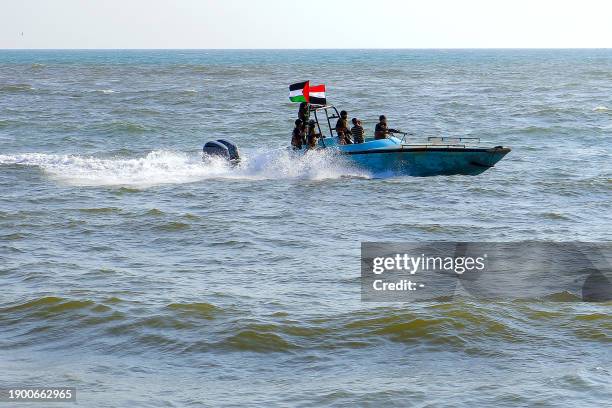 Members of the Yemeni Coast Guard affiliated with the Houthi group patrol the sea as demonstrators march through the Red Sea port city of Hodeida in...