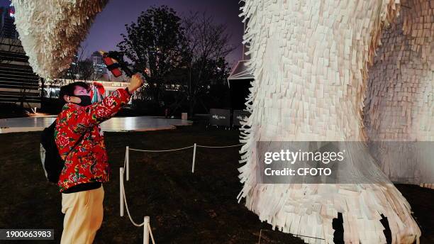 Super giant "ARCFOX" made of paper attracts people to take photos in Shanghai, China, January 4, 2024. This is the giant art installation "Let's...