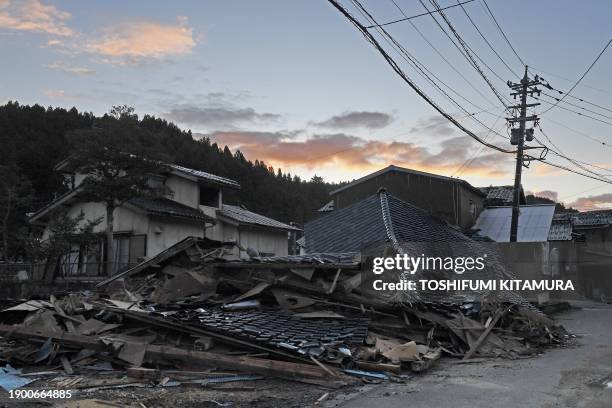 This general view shows collapsed buildings at sunrise in the town of Monzen in Wajima, Ishikawa prefecture on January 5 after a major 7.5 magnitude...