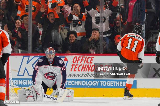 Travis Konecny of the Philadelphia Flyers reacts in front of Daniil Tarasov of the Columbus Blue Jackets after scoring a goal in the first period at...