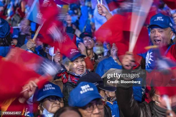 Attendees wave Taiwanese flags during a campaign event with Hou Yu-ih, presidential candidate for the Kuomintang and mayor of New Taipei City, in...