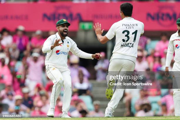 Babar Azam of Pakistan celebrates with Mir Hamza of Pakistan after combining to take the wicket of Steve Smith of Australia during Day 3 of the third...