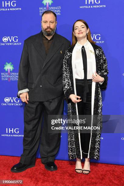 Greek director Yorgos Lanthimos and recipient of the Desert Palm achievement Award - Actress for "Poor Things" US actress Emma Stone arrives for the...