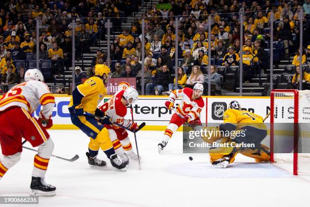 Andrew Mangiapane of the Calgary Flames passes the puck to set up a goal by Noah Hanifin of the Calgary Flames during the second period against the...