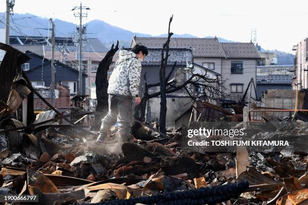 Man looks through the burned Wajima Asa-ichi, or morning market area, in the city of Wajima, Ishikawa prefecture, on January 5 after a major 7.5...