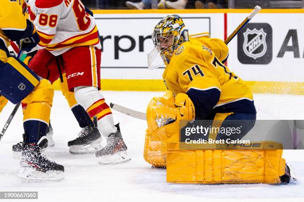 Juuse Saros of the Nashville Predators makes a save against the Calgary Flames during the second period at Bridgestone Arena on January 4, 2024 in...