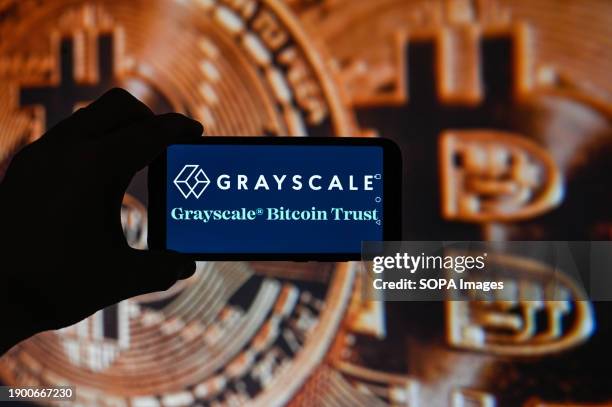 In this photo illustration a Grayscale logo is displayed on a smartphone with Bitcoin logo on the background. The US Securities and Exchange...