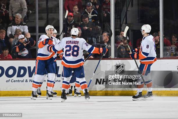 Julien Gauthier of the New York Islanders celebrates with teammate Alexander Romanov after scoring a goal against the Arizona Coyotes during the...