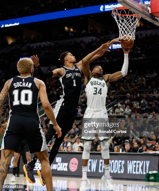 Victor Wembanyama of the San Antonio Spurs blocks the shot of Giannis Antetokounmpo of the Milwaukee Bucks in the second half at Frost Bank Center on...