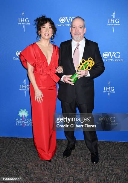 Sandra Oh and Paul Giamatti, winner of the Icon Award, pose in the press room at the 2024 Palm Springs International Film Festival Film Awards held...