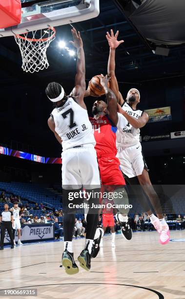 Dewayne Dedmon of the Ontario Clippers goes to the basket against David Duke Jr. #7 and Paul Watson of the Austin Spurs on January 4, 2024 at Toyota...