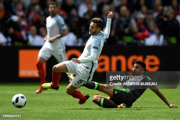 Wales' defender Neil Taylor vies with the ball with England's midfielder Adam Lallana during the Euro 2016 group B football match between England and...