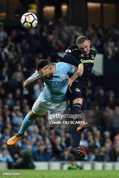 Manchester City's Argentinian defender Nicolas Otamendi vies with Everton's English striker Wayne Rooney during the English Premier League football...