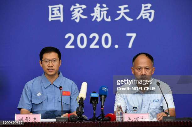 China's Mars Exploration Mission spokesperson Liu Tongjie and deputy chief of launch mission command Mao Wanbiao attend a press conference after the...