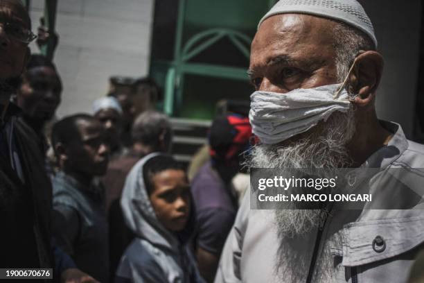 Muslim man wearing a makeshift mask as a preventive measure against the COVID-19 coronavirus leaves after performing the Friday prayer at the 23rd...