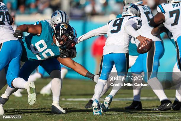 Jeremiah Ledbetter of the Jacksonville Jaguars tackles Bryce Young of the Carolina Panthers during the second half of the game at EverBank Stadium on...