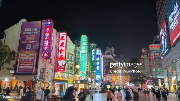 Tourists are spending money on the Nanjing Road Pedestrian Street, known as ''China's first commercial street,'' at night in Shanghai, China, on...