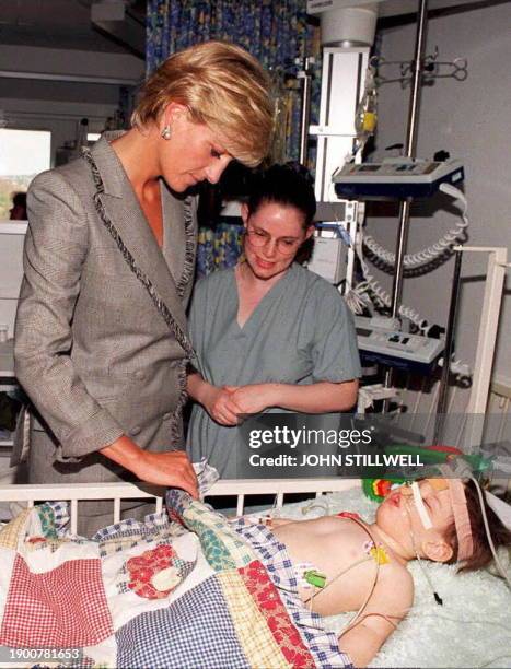 Diana, Princess of Wales visits eighteen month old Vessa Kahramani during her visit to the paediatric Intensive Care Unit at St Mary's Hospital in...